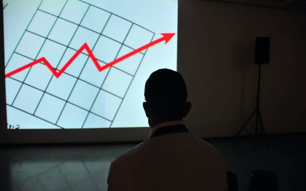 frank-busch-PzifgmBsxCc-unsplash a shadow of a man infront of a graph